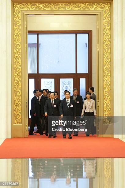 Zhang Ping, director of the Chinese National Development and Reform Commission , center, Xie Xuren, minister of finance for China, left of Zhang, and...