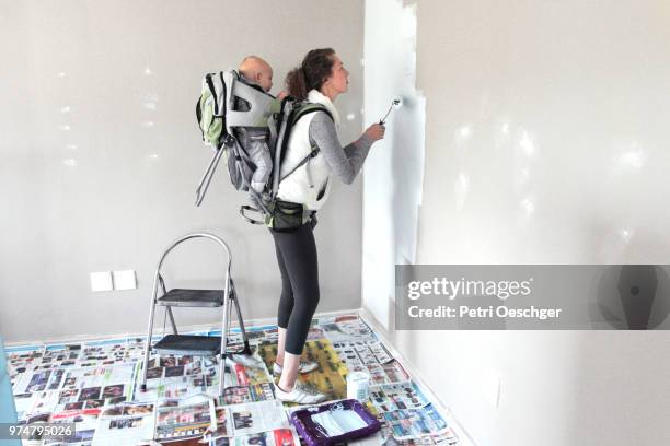 painting the playroom with baby. - new baby fotografías e imágenes de stock