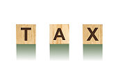 Word Tax, composed of letters on wooden construction cubes. White background, isolated Concept business, finance.