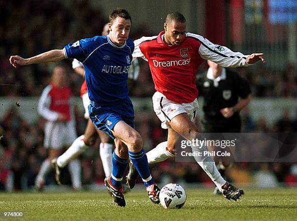 John Terry of Chelsea holds off the challenge of Thierry Henry of Arsenal during the match between Arsenal and Chelsea in the fifth round of the Axa...