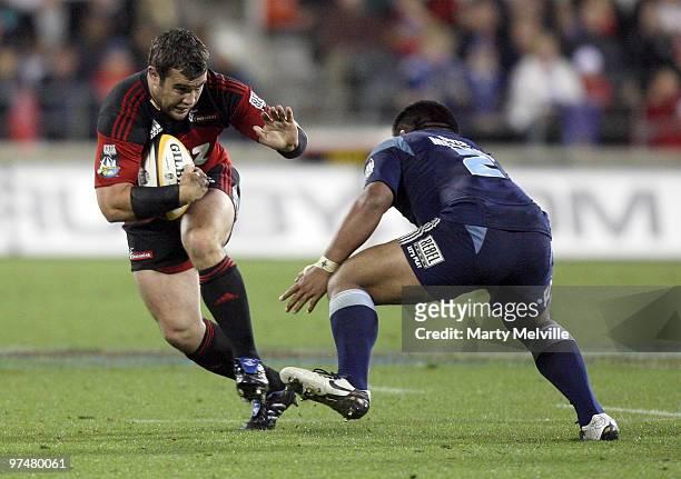Corey Flynn of the Crusaders fends off Kevin Mealamu captain of the Blues during the round four Super 14 match between the Crusaders and the Blues at...
