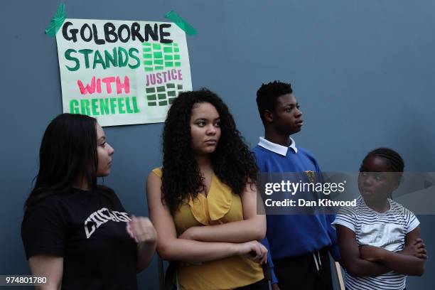 Members of the public watch as people take part in a silent march to St Mark's Park where an open Iftar will take place on the one year anniversary...