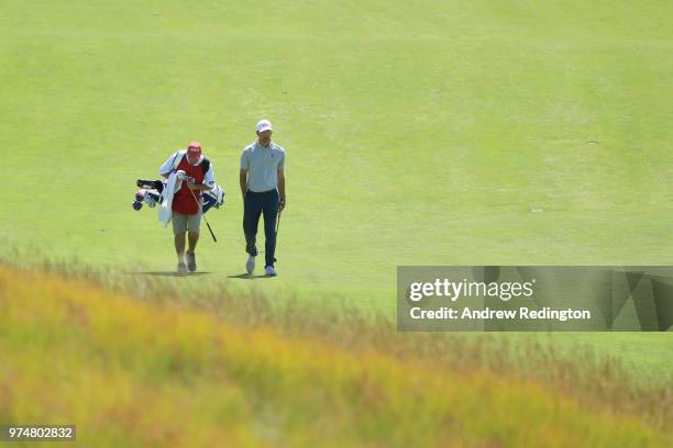 Lucas Glover of the United States and his caddie walk up the 15th green during the first round of the 2018 U.S. Open at Shinnecock Hills Golf Club on...