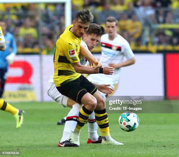 Maximilian Philipp of Dortmund and Panagiotis Retsos of Leverkusen battle for the ball during the Bundesliga match between Borussia Dortmund and...