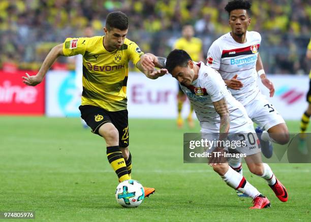 Christian Pulisic of Dortmund and Charles Aranguiz of Leverkusen battle for the ball during the Bundesliga match between Borussia Dortmund and Bayer...