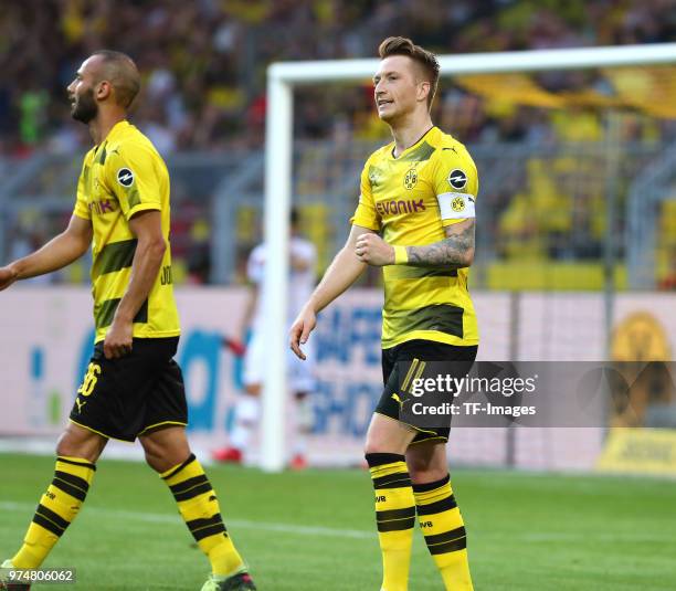 Marco Reus of Dortmund celebrates after scoring his team`s fourth goal with Oemer Toprak of Dortmund and during the Bundesliga match between Borussia...