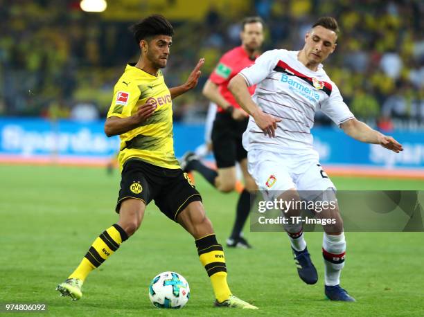 Mahmoud Dahoud of Dortmund and Dominik Kohr of Leverkusen battle for the ball during the Bundesliga match between Borussia Dortmund and Bayer 04...