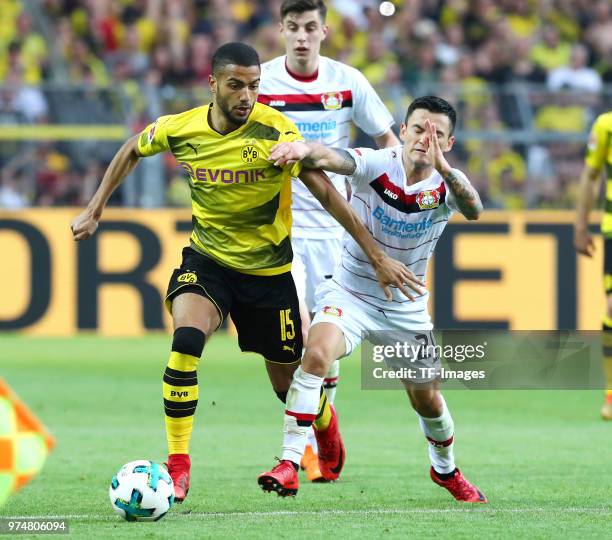Jeremy Toljan of Dortmund and Charles Aranguiz of Leverkusen battle for the ball during the Bundesliga match between Borussia Dortmund and Bayer 04...