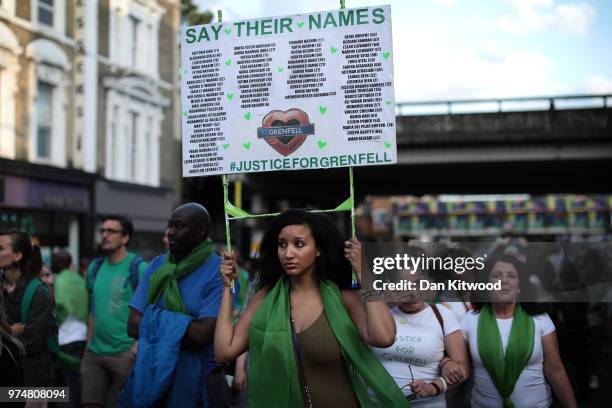 People take part in a silent march to St Mark's Park where an open Iftar will take place on the one year anniversary of the Grenfell Tower fire on...