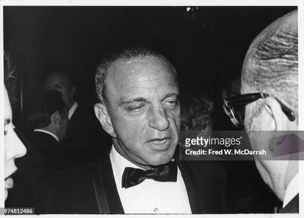 American attorney Roy Cohn speaks with an unidentified man during his birthday party at the Seventh Regiment Armory , New York, New York, February...
