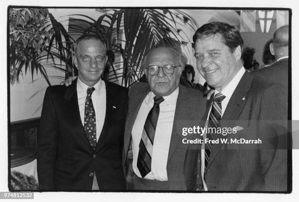 American attorney Roy Cohn poses with two unidentified men during a Citymeals-on-Wheels Restaurant Week benefit at the Water Club , New York, New...