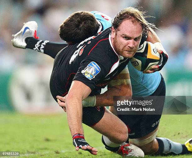 Andy Goode of the Sharks is tackled during the round four Super 14 match between the Waratahs and the Sharks at the Sydney Football Stadium on March...