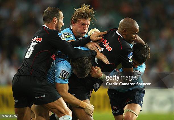 Pietersen of the Sharks is tackled during the round four Super 14 match between the Waratahs and the Sharks at the Sydney Football Stadium on March...