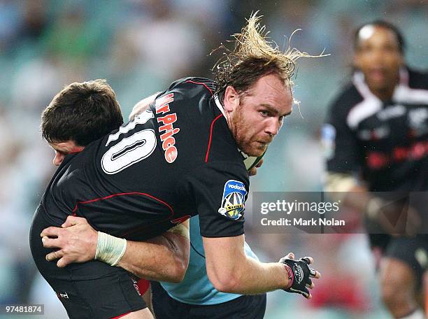 Andy Goode of the Sharks is tackled during the round four Super 14 match between the Waratahs and the Sharks at the Sydney Football Stadium on March...