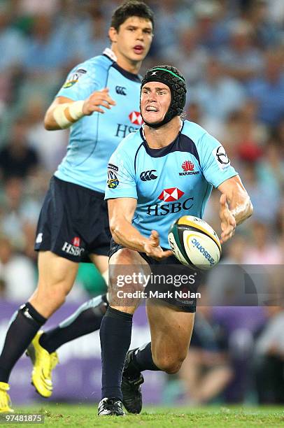 Berrick Barnes of the Waratahs passes during the round four Super 14 match between the Waratahs and the Sharks at the Sydney Football Stadium on...