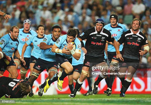 Tom Carter of the Waratahs makes a break during the round four Super 14 match between the Waratahs and the Sharks at the Sydney Football Stadium on...