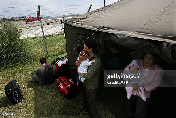 Chilean mothers with their children wait Concepcion Airport for Santiago on free militar fligt after the quake, Chile, on March 5, 2010. Chileans...