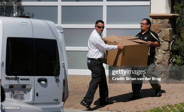 Los Angeles Sheriff's investigators remove a box from a home at 8620 Santa Susana Place June 8 2012 in Canoga Park. Sheriff's officials served a...