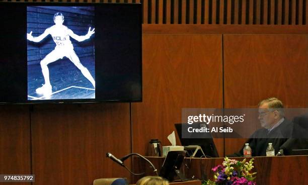 Image of Gavin Smith when he played basketball for UCLA is shown as Judge Stephen A. Marcus listens to Deputy District Attorney Bobby Grace deliver...
