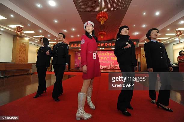 Group of Chinese women parade a special line of work clothes fashion for women in Beijing on March 4 ahead of the International Women's Day...