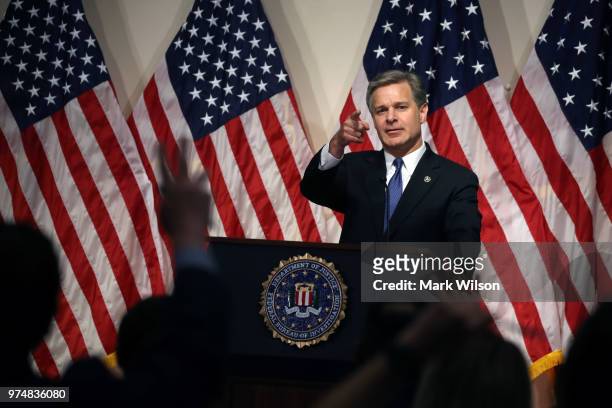 Director is Christopher A. Wray speaks to the media during a news conference at FBI Headquarters, on June 14, 2018 in Washington, DC. Earlier today...