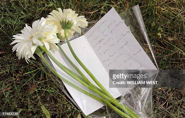 Flowers and a card lay close to the site of where the body of three-year-old Indian boy Gurshan Singh was found, in Melbourne on March 5, 2010....