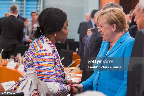 June 2018, Berlin, Germany: Chancellor Angela Merkel speaks with Virginia Wangare Greiner from the association "Maisha - Selbsthilfegruppe...