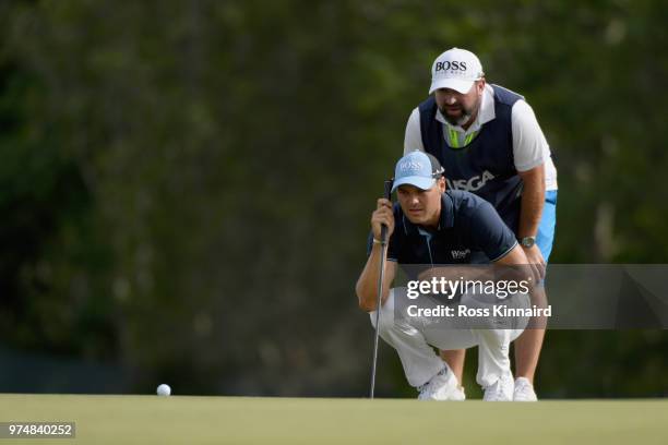 Martin Kaymer of Germany and caddie Craig Connelly line up a putt on the second green during the first round of the 2018 U.S. Open at Shinnecock...