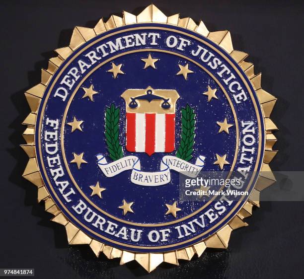 The FBI seal is attached to a podium prior to Director is Christopher A. Wray speakin at a news conference at FBI Headquarters, on June 14, 2018 in...