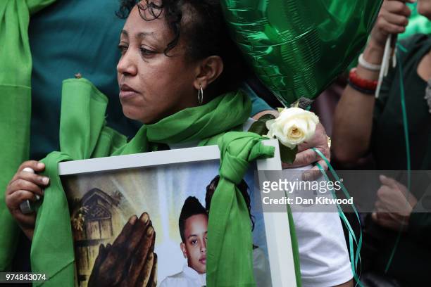 Woman looks emotional as she takes part in the walk to the Wall of Truth to mark the one year anniversary of the Grenfell Tower fire on June 14, 2018...