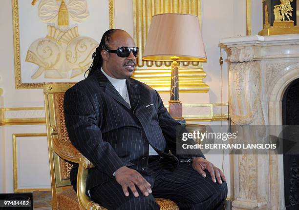 Music icon Stevie Wonder sits before being awarded the Commandeur des Arts et des Lettres by French Culture Minister Frederic Mitterrand at the...