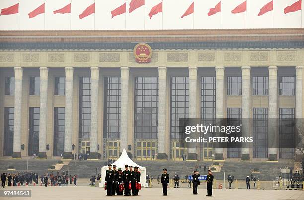 Paramilitary police march on Tiananmen Square outside the Great Hall of the People before the closing ceremony of the Chinese People's Political...