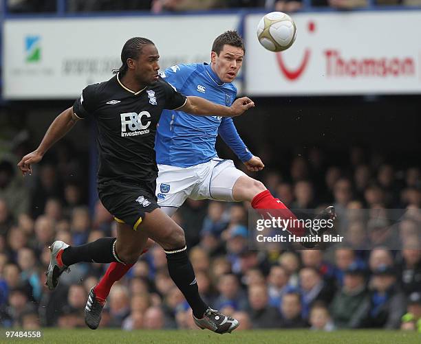 Steve Finnan of Portsmouth kicks clear of Cameron Jerome of Birmingham during the FA Cup sponsored by E.on quarter final match between Portsmouth and...