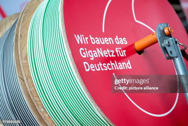 June 2018, Germany, Hanover: A cable drum with the writing 'Wir bauen das GigaNetz für Deutschland' at a stand from Vodafone at the digitalisation...