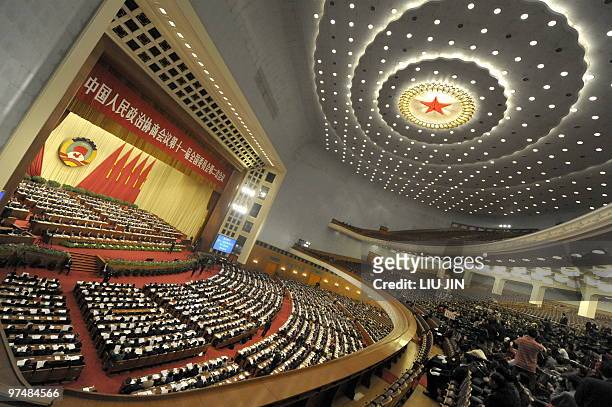 Delegates attend the closing session of the Chinese People's Political Consultative Conference at the Great Hall of the People in Beijing on March...
