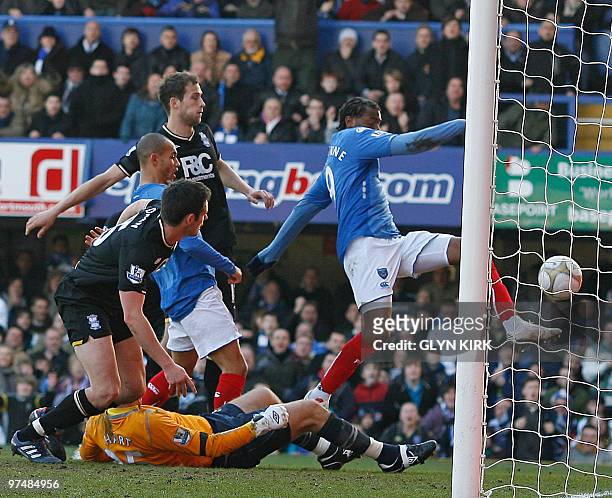 Portsmouth's French striker Frederic Piquionne scores the opening goal of the FA Cup Quarter Final football match between Portsmouth and Birmingham...