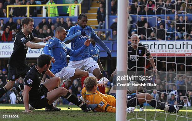 Frederic Piquionne of Portsmouth scores his and his team's first goal during the FA Cup sponsored by E.on quarter final match between Portsmouth and...