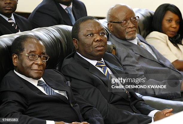 Zimbabwean Prime minister Morgan Tsvangirai , is flanked by Zimbabwean President Robert Mugabe and Vice-President John Nkomo , as he attends a...