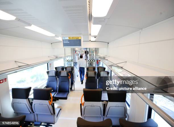 June 2018, Wegberg, Germany: A Journalistsit walks through the passenger compartment during a test drive in of the new Rhine-Ruhr Express . The train...