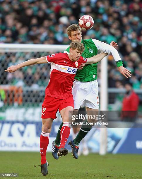 Per Mertesacker of Bremen and Pavel Pogrebnyak of Stuttgart compete for the ball during the Bundesliga match between Werder Bremen and VfB Stuttgart...