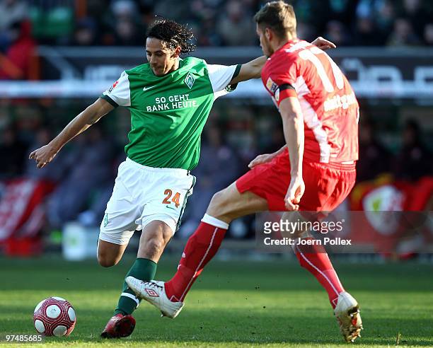 Claudio Pizarro of Bremen and Matthieu Delpierre of Stuttgart compete for the ball during the Bundesliga match between Werder Bremen and VfB...