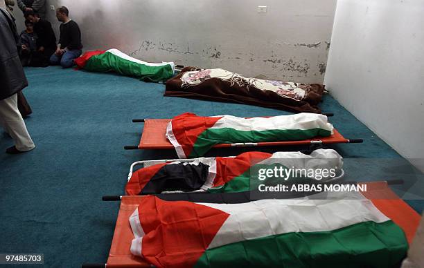 The bodies of a Palestinian family killed the day before in a car crash with an Israeli army vehicle, lay on the floor during their funeral in the...