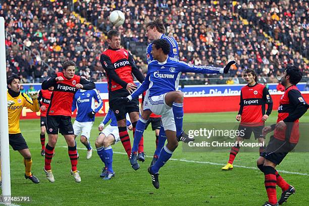 Alexander Meier of Frankfurt, Benedikt Hoewedes and Joel Matip of Schalke go up for a header during the Bundesliga match between Eintracht Frankfurt...