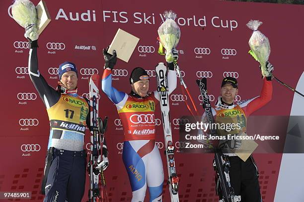 Aksel Lund Svindal of Norway takes 2nd place, Didier Cuche of Switzerland takes 1st place, Klaus Kroell of Austria takes 3rd place during the Audi...