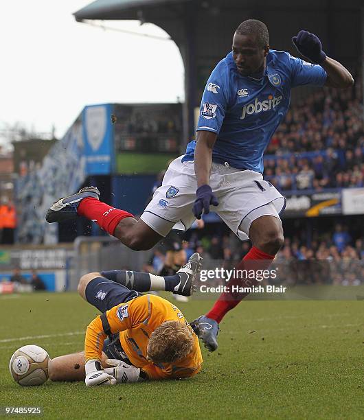 John Utaka of Portsmouth leaps Joe Hart goalkeeper for Birmingham during the FA Cup sponsored by E.on quarter final match between Portsmouth and...