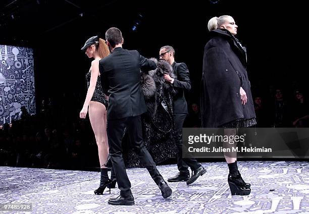 Designers Viktor & Rolf and a model perform during the Viktor & Rolf Ready to Wear Show as part of the Paris womens wear Fashion Week Fall Winter...