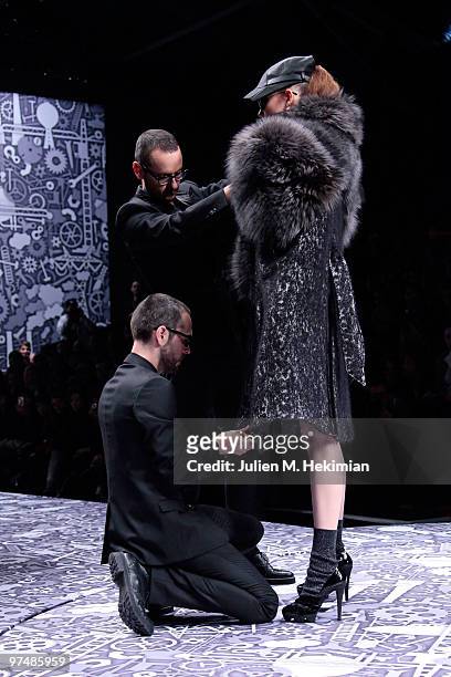 Designers Viktor & Rolf and a model perform during the Viktor & Rolf Ready to Wear Show as part of the Paris womens wear Fashion Week Fall Winter...