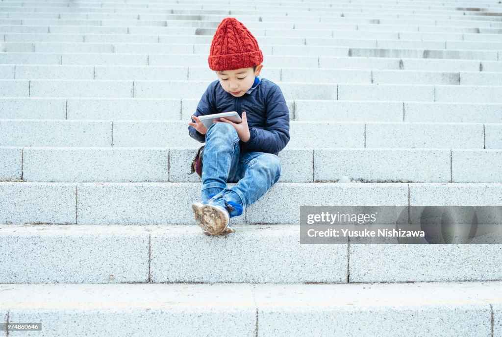 A boy who operates a tablet