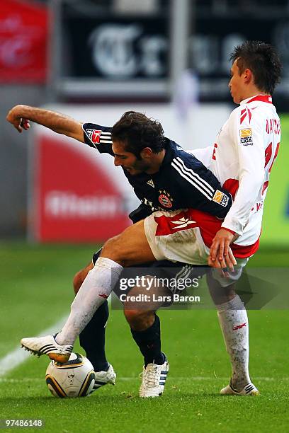 Hamit Altintop of Muenchen is challenged by Adam Matuschyk of Koeln during the Bundesliga match between 1. FC Koeln and FC Bayern Muenchen at...