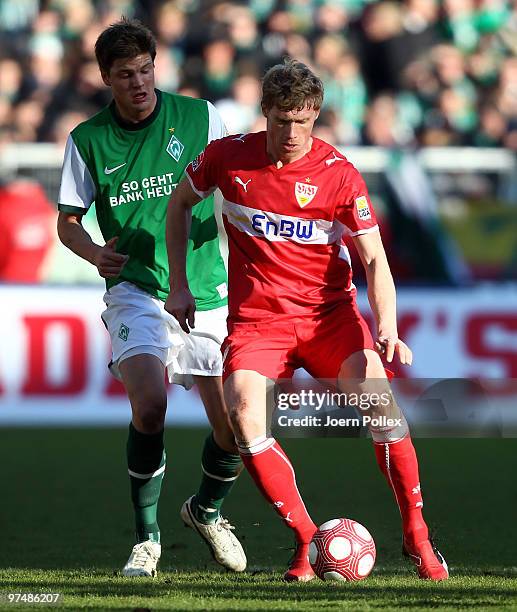 Sebastian Proedl of Bremen and Pavel Pogrebnyak of Stuttgart compete for the ball during the Bundesliga match between Werder Bremen and VfB Stuttgart...